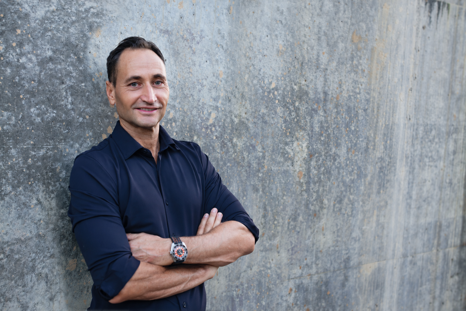 John-Oliver Breckoff in front of a textured wall